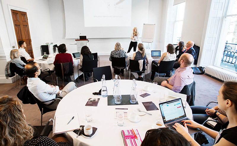 Photo of Alexis delivering training to a group