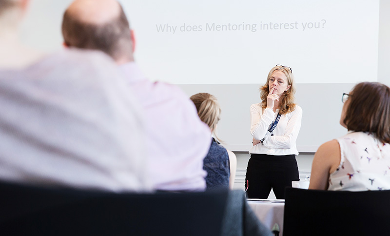 Photo of Alexis delivering training to a group